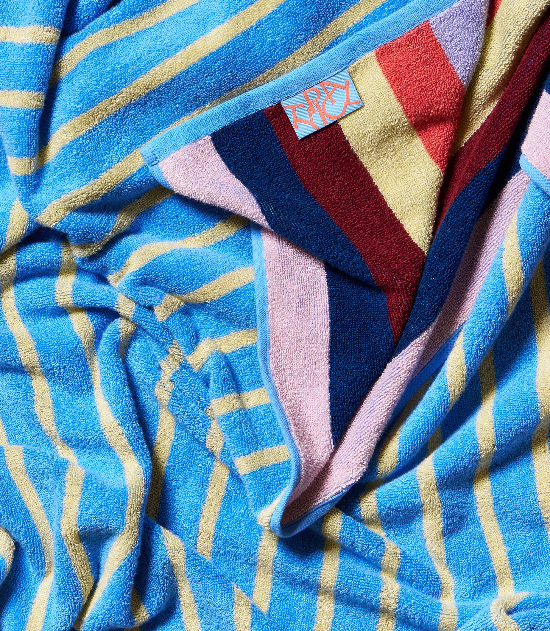 Colorful towel with a brand label on a blue background