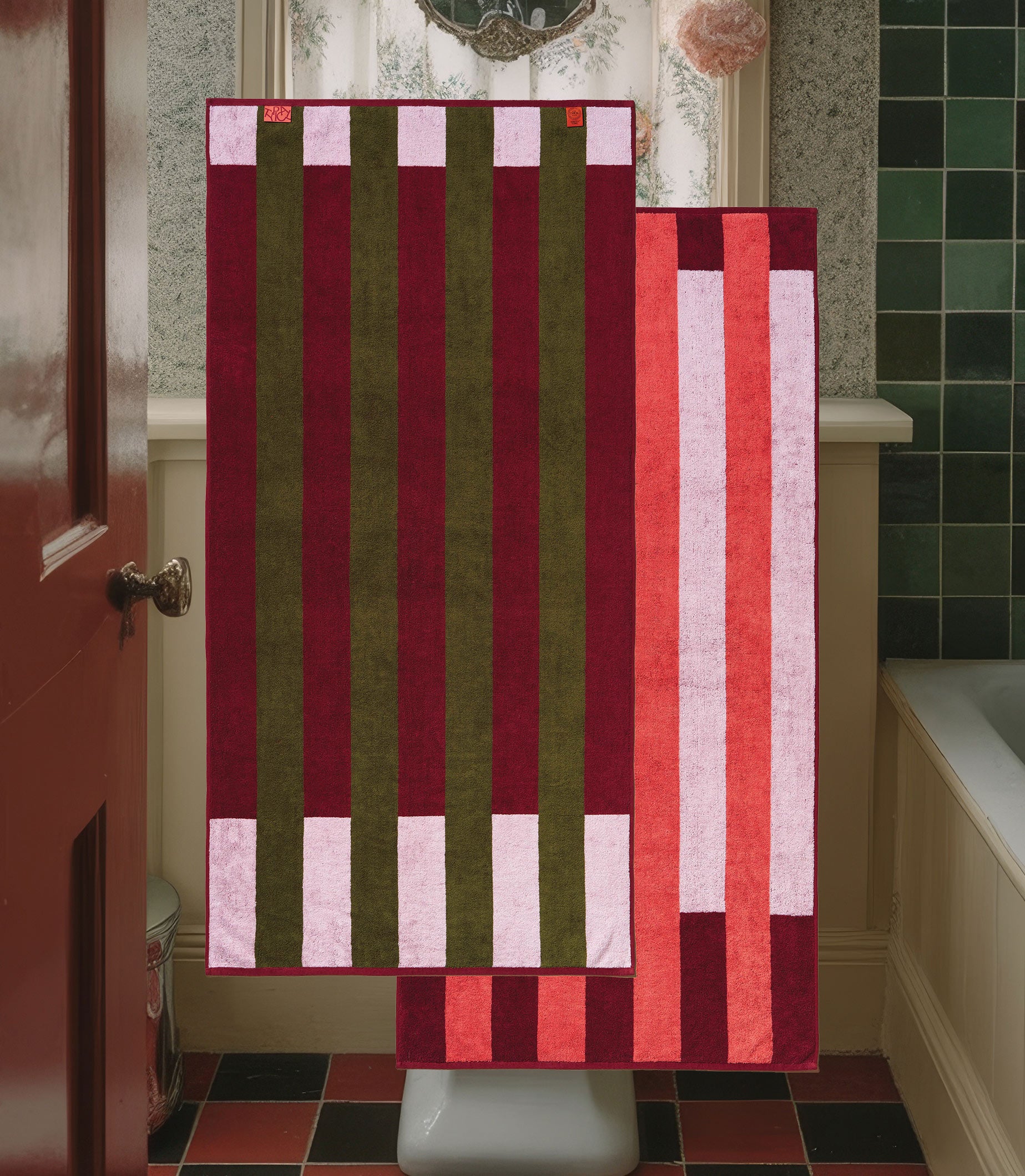 Striped towel hanging on a towel rack in a bathroom.