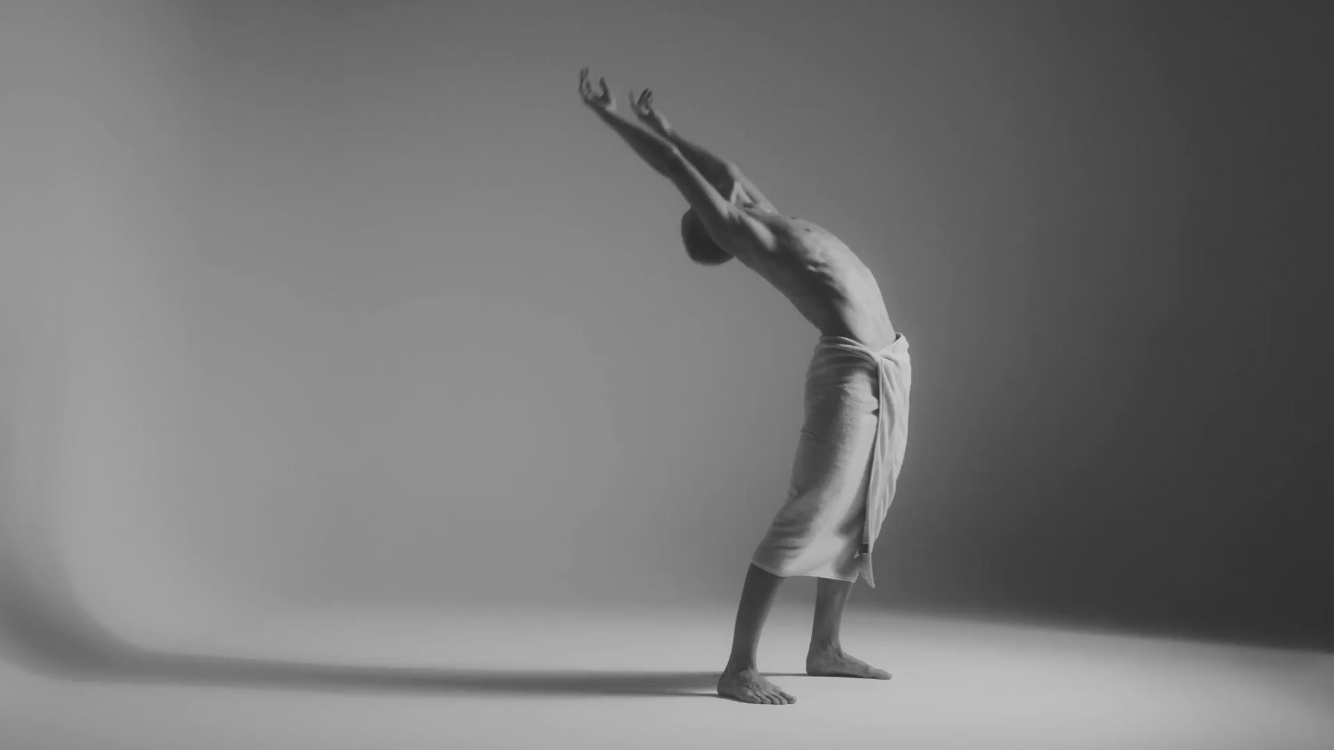 A person dancing with a towel wrapped around their waist